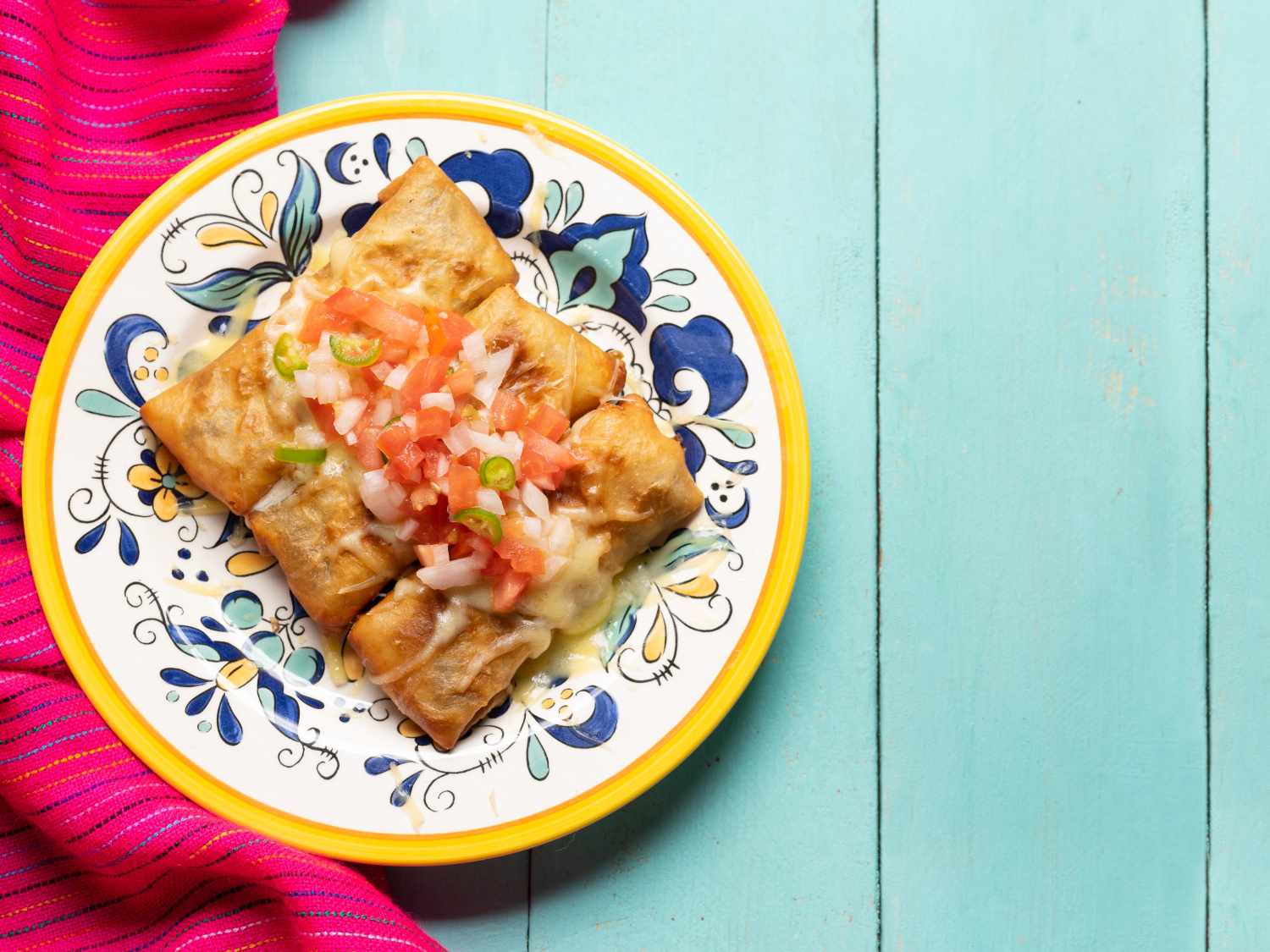 Overhead image of chimichanga burritos on a plate