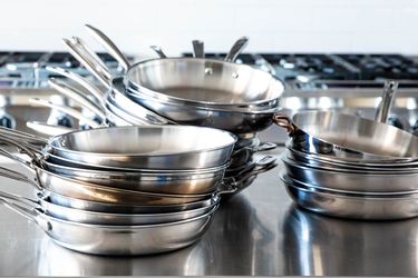 Best stainless steel skillets displayed in stacks on stainless steel counter 