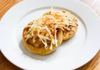 Two cheese and bean pupusas topped with cabbage slaw