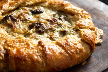 Closeup of a broccoli and cheese galette, fresh from the oven.