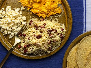 Gallopinto served with warm corn tortillas, scrambled eggs, and queso fresco on the side