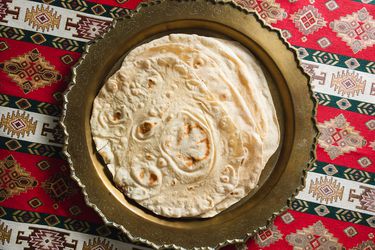 Stack of baked lavash on a serving platter.