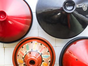 overhead shot of four tagines on a tile surface