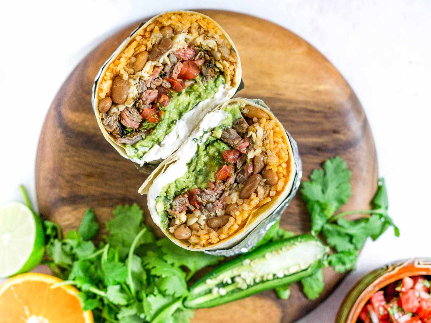 A cross section of a Mission burrito on a cutting board