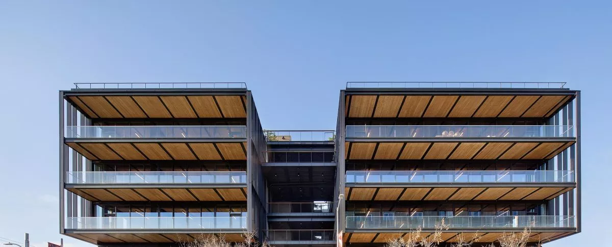 Exterior view of multistory balconies on large modern timber office building at 843 N Spring Street