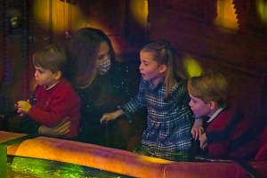 Britain's Kate, Duchess of Cambridge, Prince Louis and Princess Charlotte and Prince George attend a special pantomime performance at London's Palladium Theatre, Friday Dec. 11, 2020, hosted by The National Lottery, to thank key workers and their families for their efforts throughout the COVID-19 pandemic. (Aaron Chown/Pool via AP)