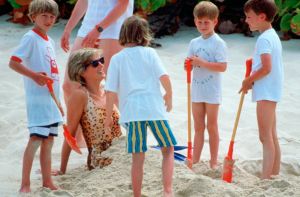 NECKER ISLAND - APRIL 11:  Diana, Princess Of Wales, Being Buried In The Sand By Her Sons, Prince William And Prince Harry During A Holiday On Necker Island. Princess Diana Is Wearing A Leopard Sking Swimming Costume.  (Photo by Tim Graham Photo Library via Getty Images)