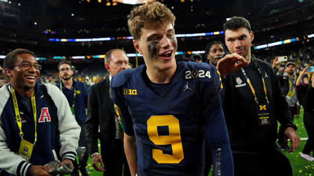 J.J. McCarthy walks off the field smiling