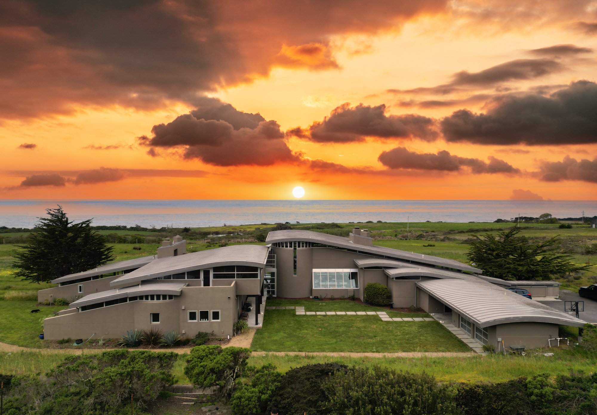 Overview of home with sunset photo.