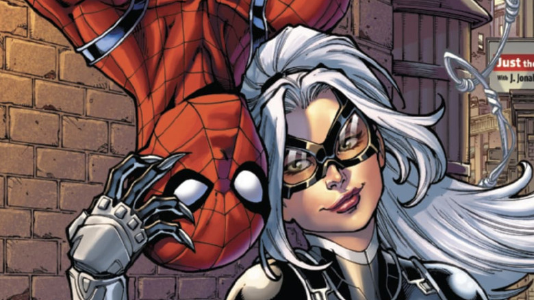 Black Cat petting Spider-Man's head, who's hanging upside down