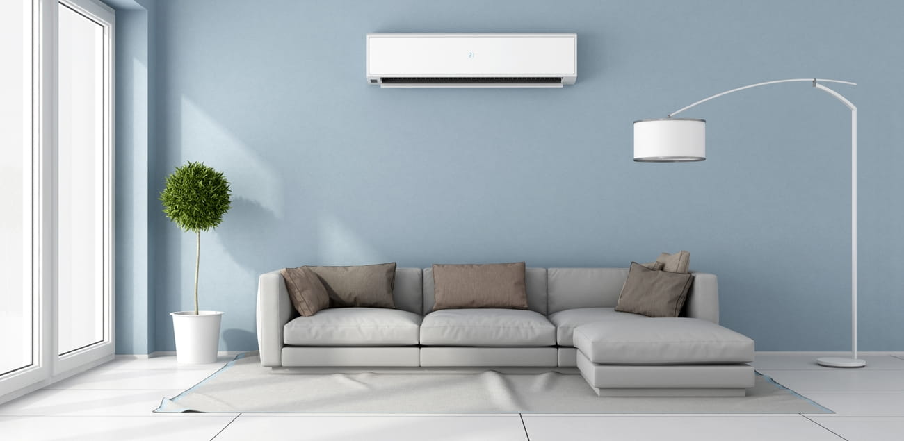 Beginner's Guide: How to Install a Mini Split Heat Pump. Ascetic Scandinavian interior with angular sofa and blue walls in the living