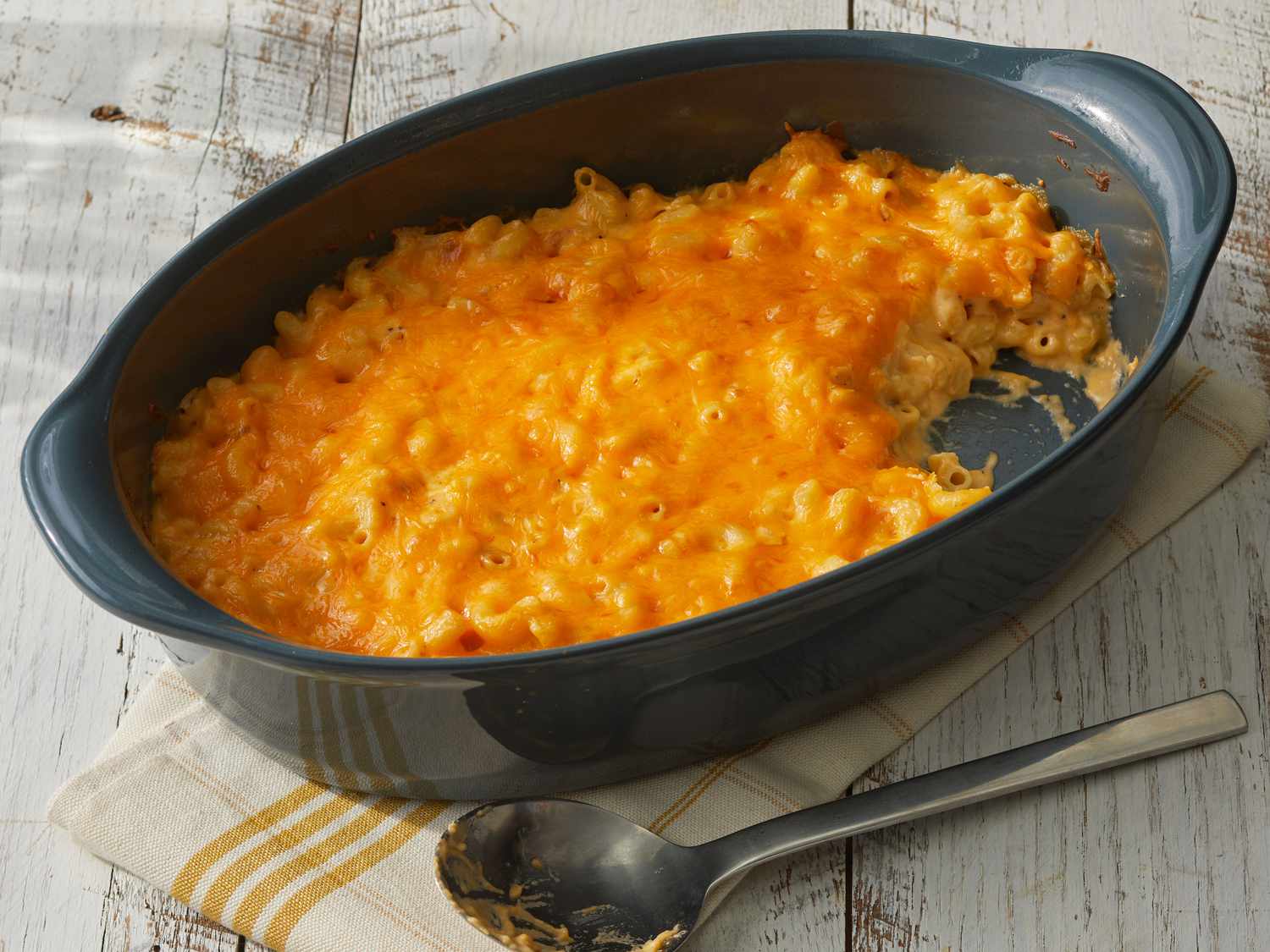 Southern Living Classic Baked Macaroni and Cheese in the dish to serve with a serving scooped out