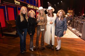 Trisha Yearwood, Lainey Wilson, Terri Clark, and other ladies on stage at the Grand Ole Opry