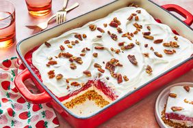 Strawberry-Pretzel Jello Salad in a red dish with strawberry linen