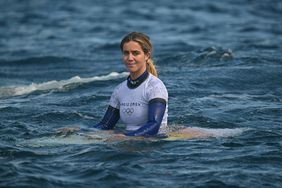 Caroline Marks Sitting on Board In Water