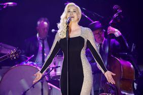 Kellie Pickler in black and silver dress at microphone