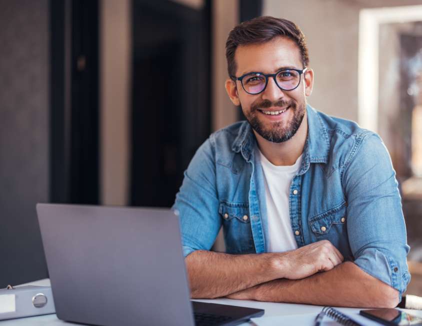 Man in front of Computer using Online Library Archive Systems