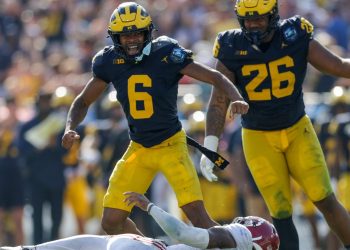 Dec 31, 2024; Tampa, FL, USA;  Alabama Crimson Tide quarterback Jalen Milroe (4) is sacked by Michigan Wolverines defensive back Brandyn Hillman (6) in the third quarter during the ReliaQuest Bowl at Raymond James Stadium. Mandatory Credit: Nathan Ray Seebeck-Imagn Images