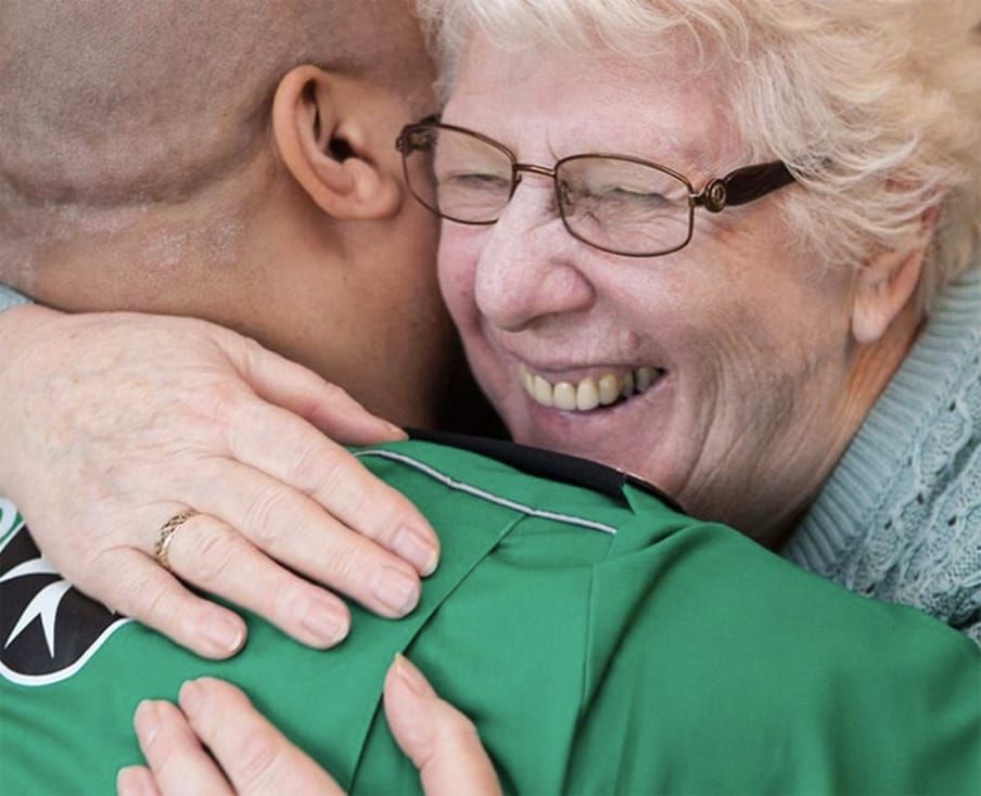 paramedic hugging an elderly lady