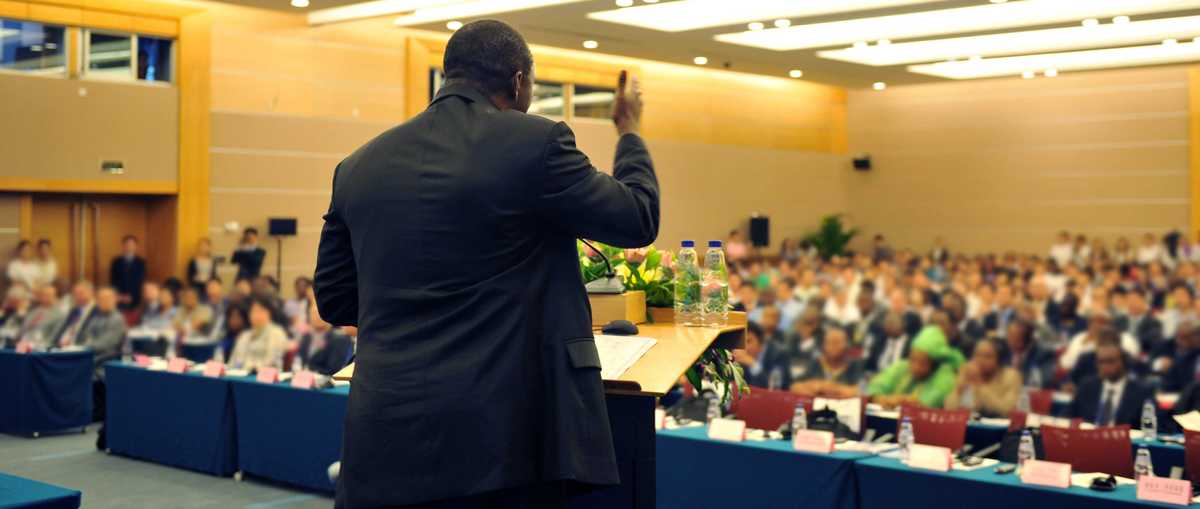 image of speaker in front of an audience