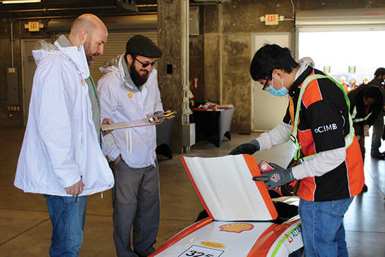 SwRI’s Jared Cavaliere (second from left) collaborates with a Shell employee.