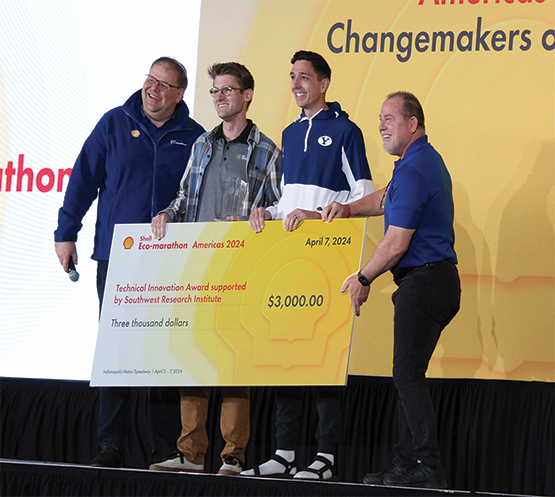 SwRI Vice President Steve Marty (right) presents the Technical Innovation Award to the leaders of the Brigham Young University team.