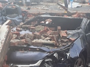 A brick wall on West Dominick Street was blown down, and many of the bricks landed on cars in front of the building. This  car caught fire after being hit by the bricks.