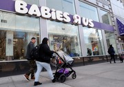 Queens residents Carlos Lopes, left, and Katiria Maldonado and their young child leave Babies R Us after shopping at Manhattan's Union Square store in New York, Wednesday, Jan. 24, 2018. (AP Photo/Kathy Willens)