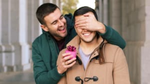 A man surprising someone with a gift