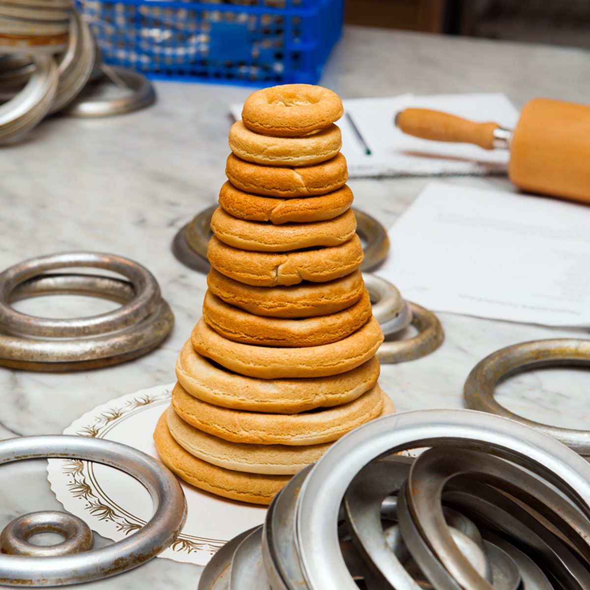 Traditional Norwegian marzipan ring cake - kransekake - seen from side with crackers and Norwegian flags. 