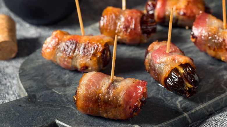 Bacon-wrapped dates on plate