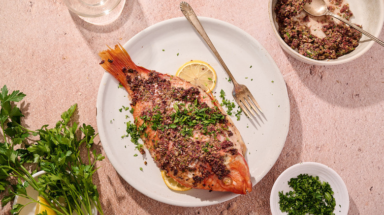 whole baked tilapia on plate