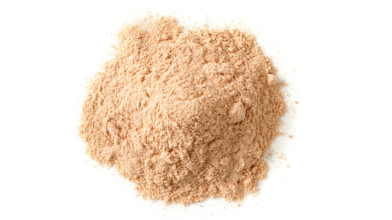 Lucuma powder on white background