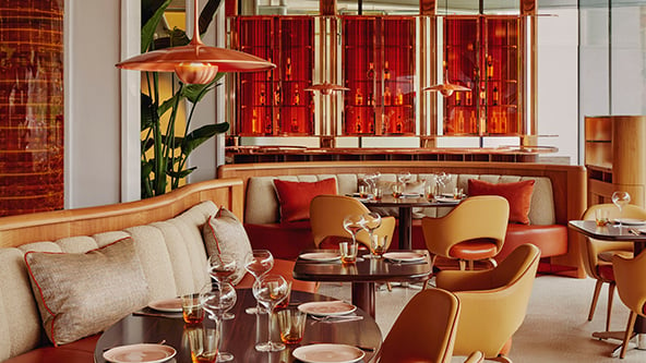 Restaurant interior of abc kitchens. Tables and chairs are dotted around the room