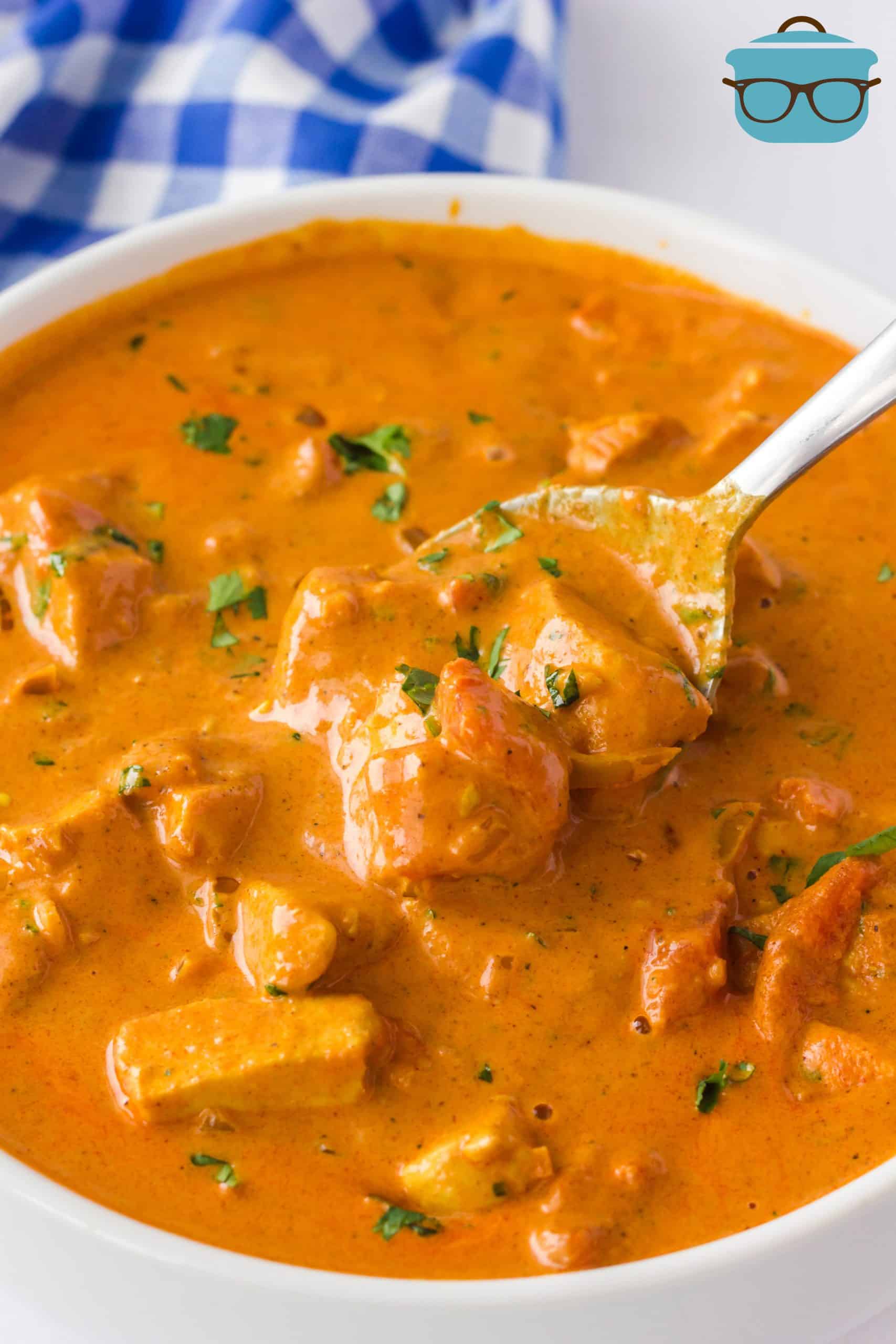 Bowl of Creamy Butter Chicken with spoon in bowl.