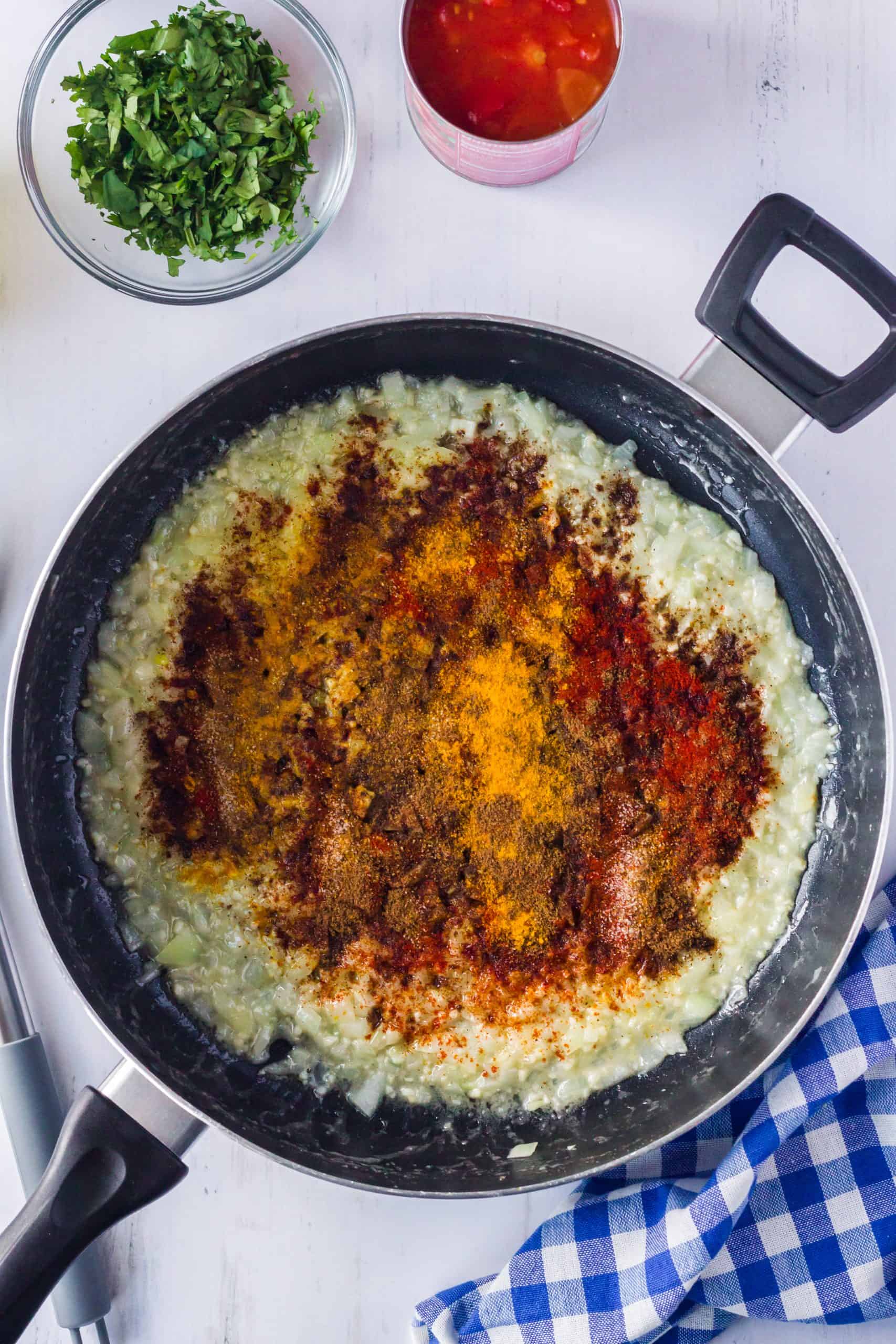 Butter, onion and spices added to skillet to cook.