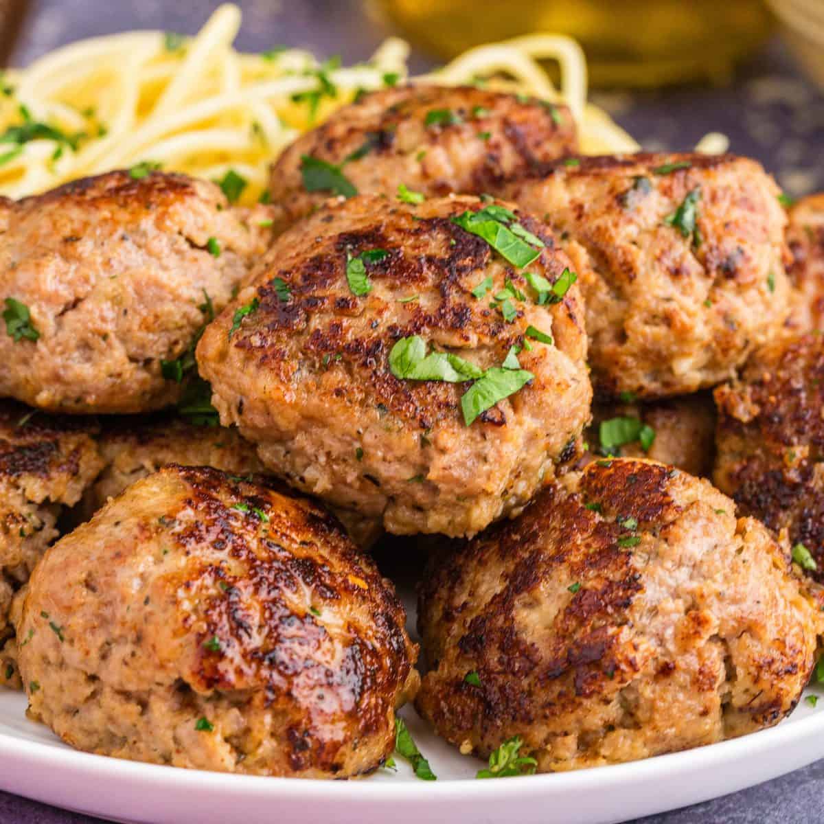 Square image of plated meatballs with parsley