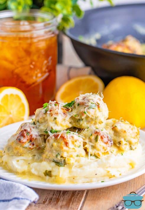 A plate with Chicken Piccata Meatballs lathered in tons of sauce.