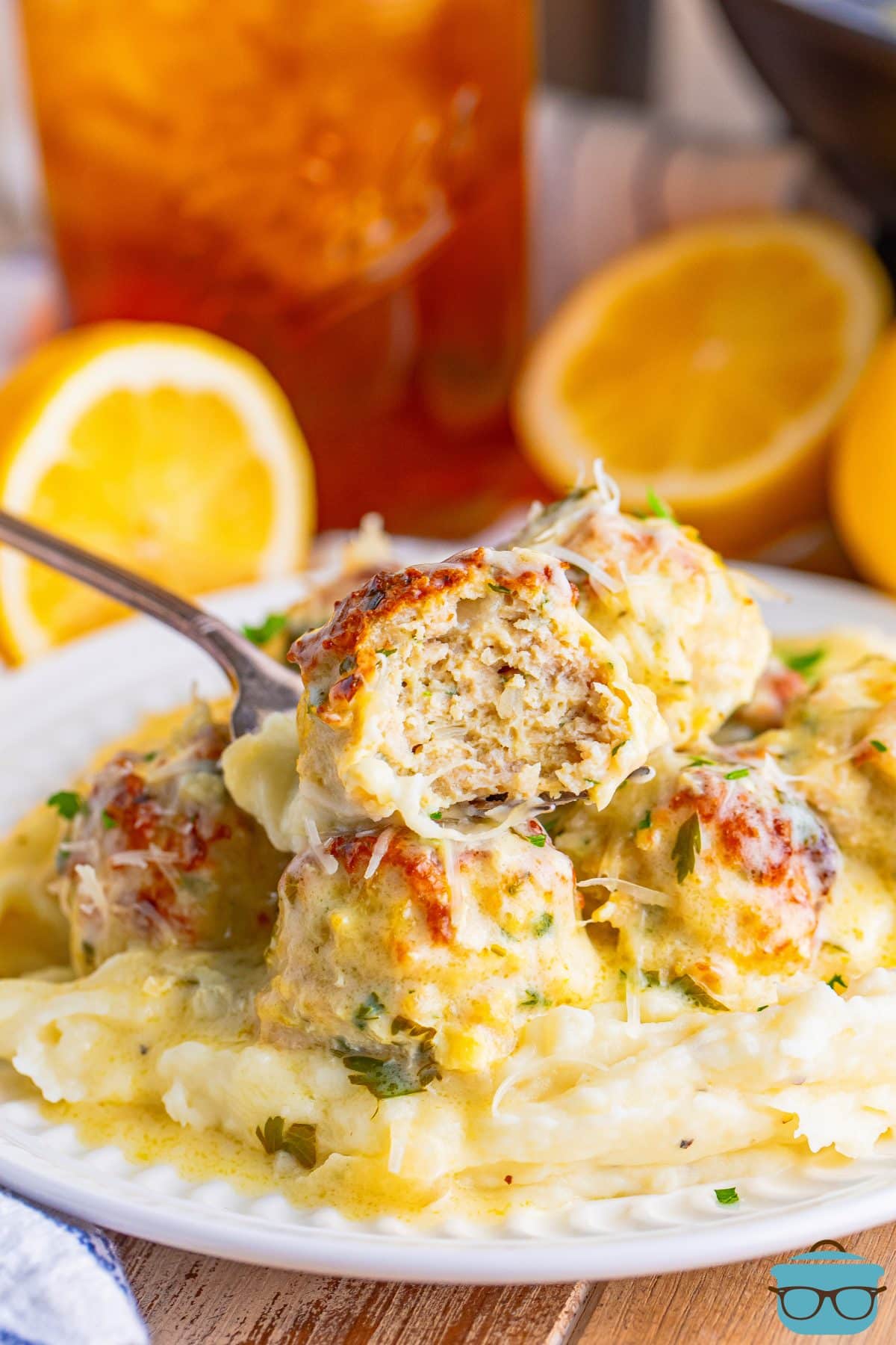 A fork holding a bite of Chicken Piccata Meatballs.