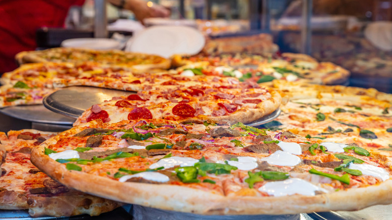 Pizzas in pizzeria shop display; peperoni, margarita, veggie