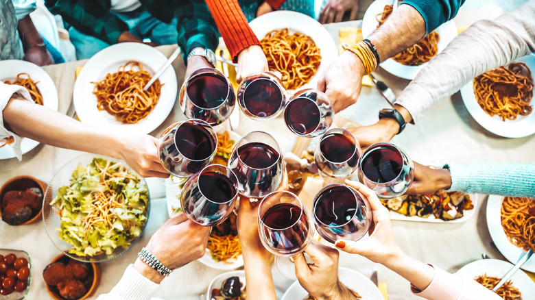 friends toasting at dinner party