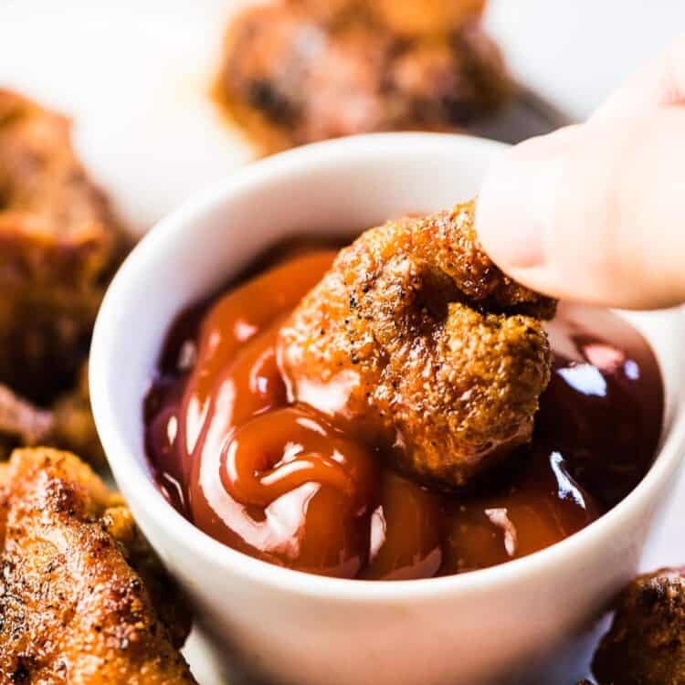 Easy chicken bites being dipped into ketchup.