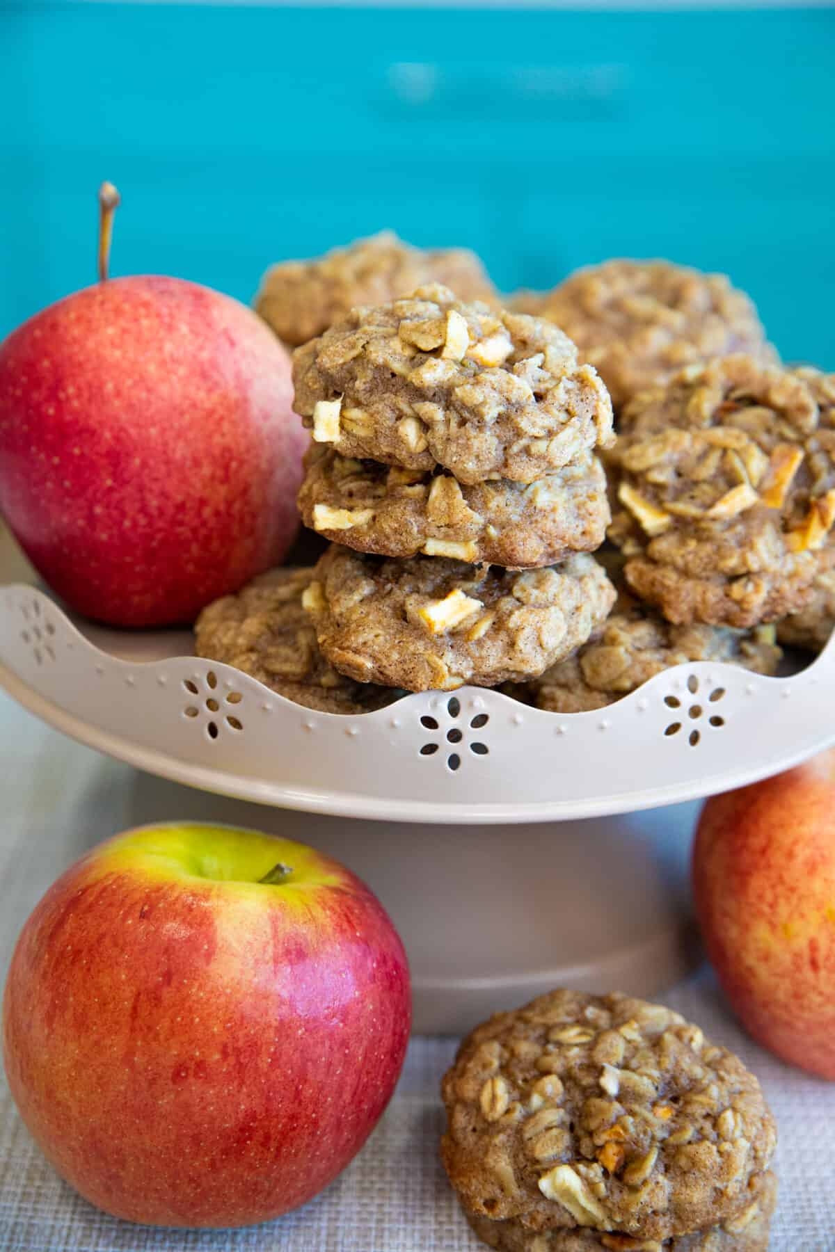 apple oatmeal cookies on a cake stand with apples 