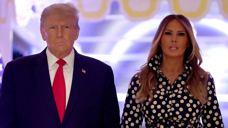 Donald Trump Melania Trump frowning, holding hands