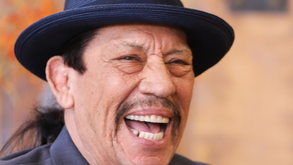 Actor Danny Trejo sporting a ponytail 