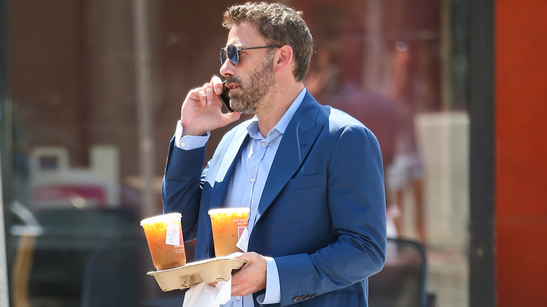 Ben Affleck carrying Dunkin Donuts coffees 