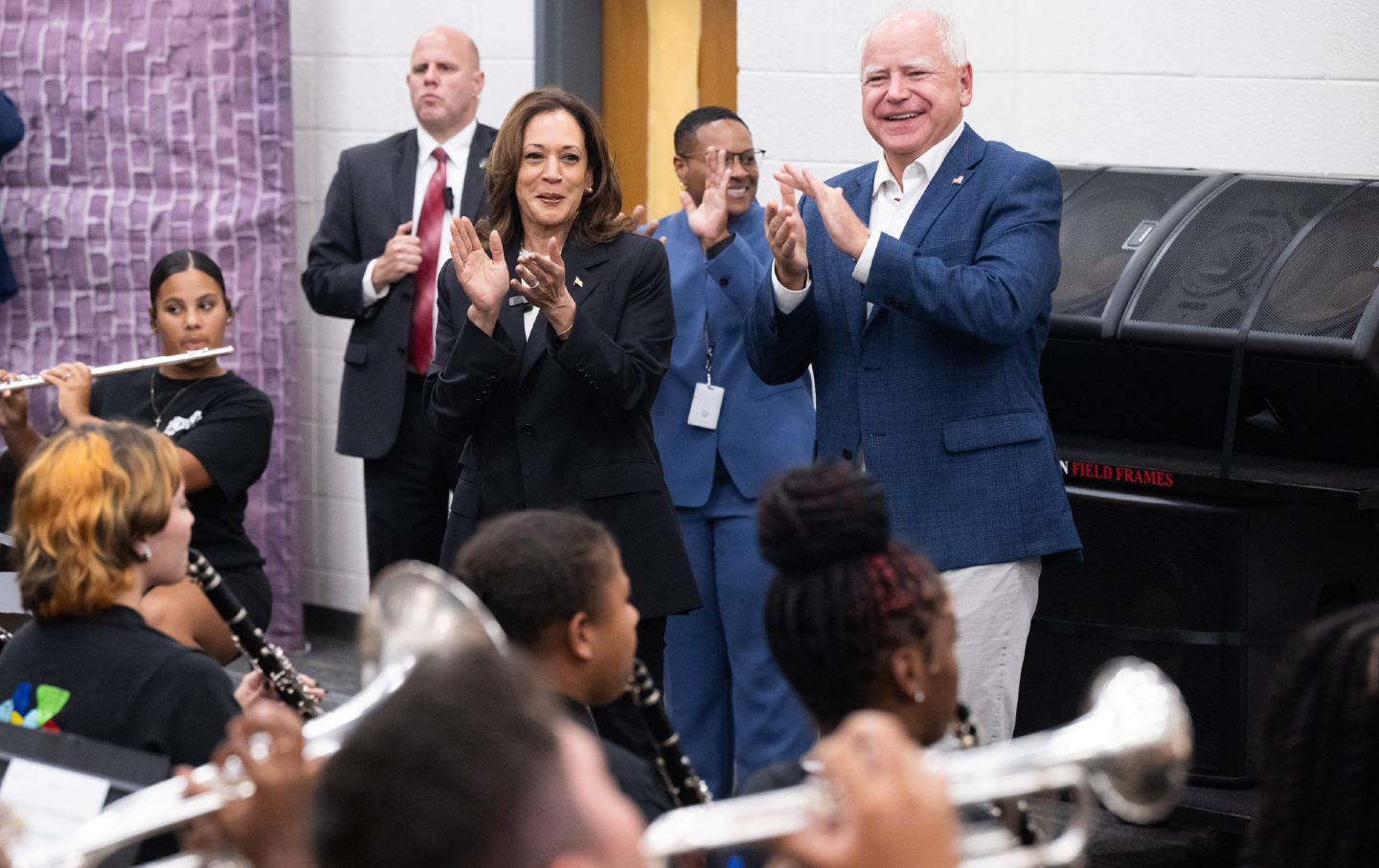 Democratic presidential candidate Vice President Kamala Harris and her running mate, Governor Tim Walz, enjoy music by members of the marching band at Liberty County High School in Hinesville, Georgia, August 28, 2024, as they travel across the state on a two-day campaign bus tour.