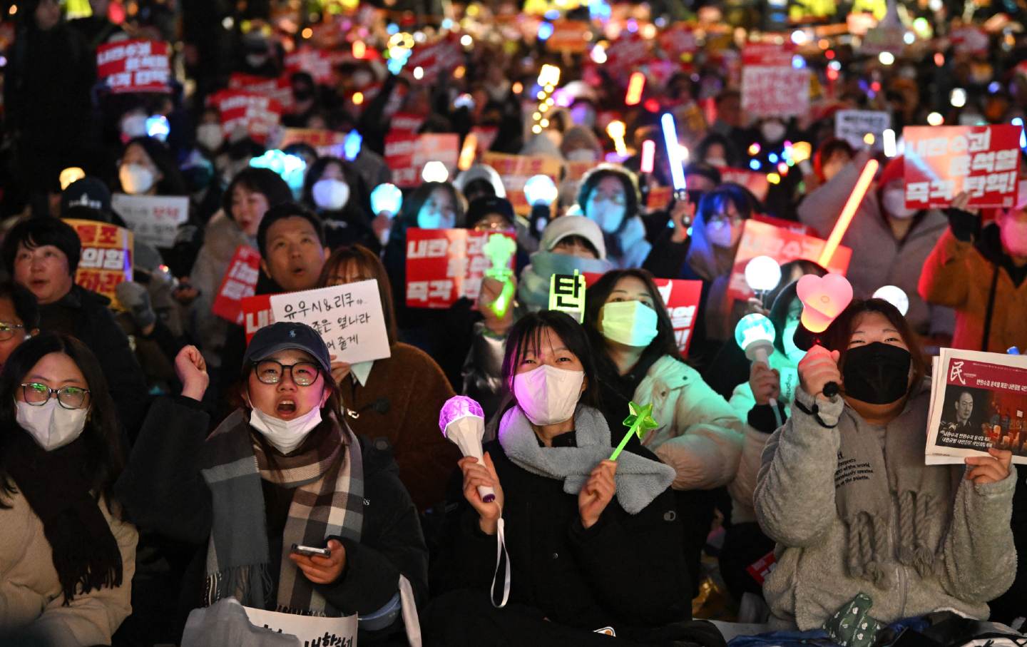 Protesters wave light sticks during a demonstration demanding President Yoon Suk Yeol's resignation outside the National Assembly in Seoul on December 10, 2024.