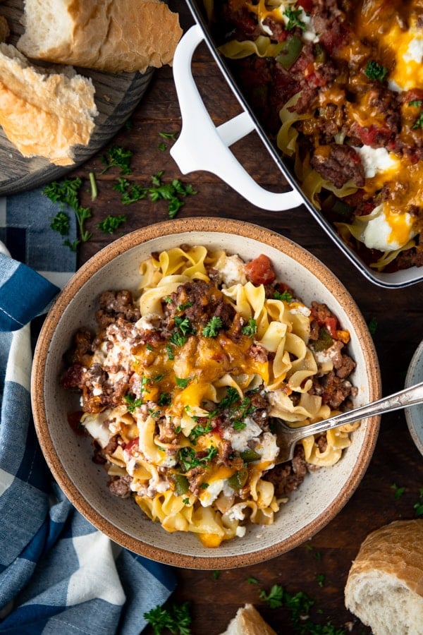 Overhead shot of a bowl of hamburger casserole garnished with fresh parsley.