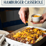 Process shot of hamburger casserole with text title box at top.